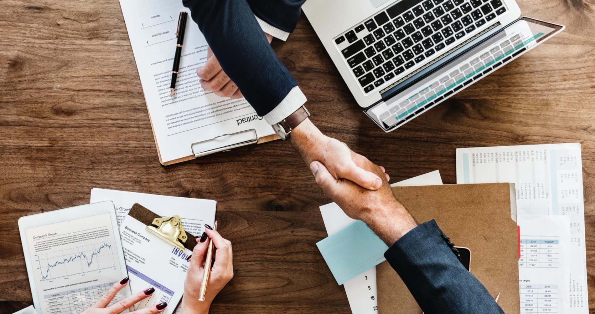 this is an image of business people agreeing on contract at meeting.