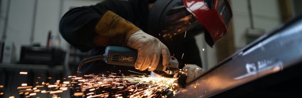 image of worker using angle grinder in workshop